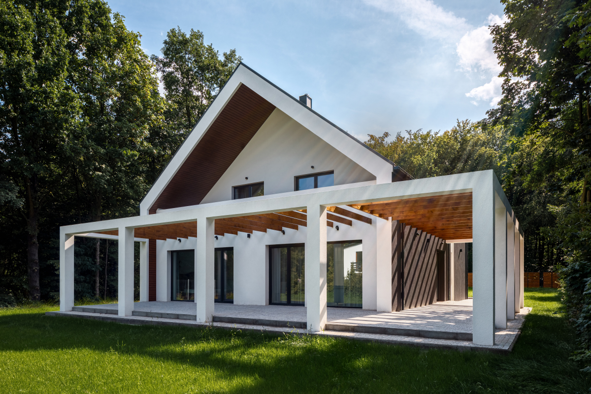 une maison neuve dans un jardin avec une grande terrasse